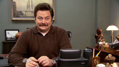 Animated gif with a short video from the show Parks and Recreation showing a person excited and nervously smiling
