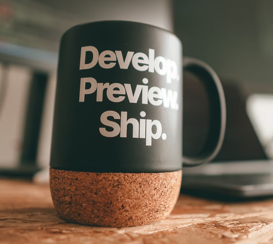 A coffee mug with the text: Develop. Preview. Ship.