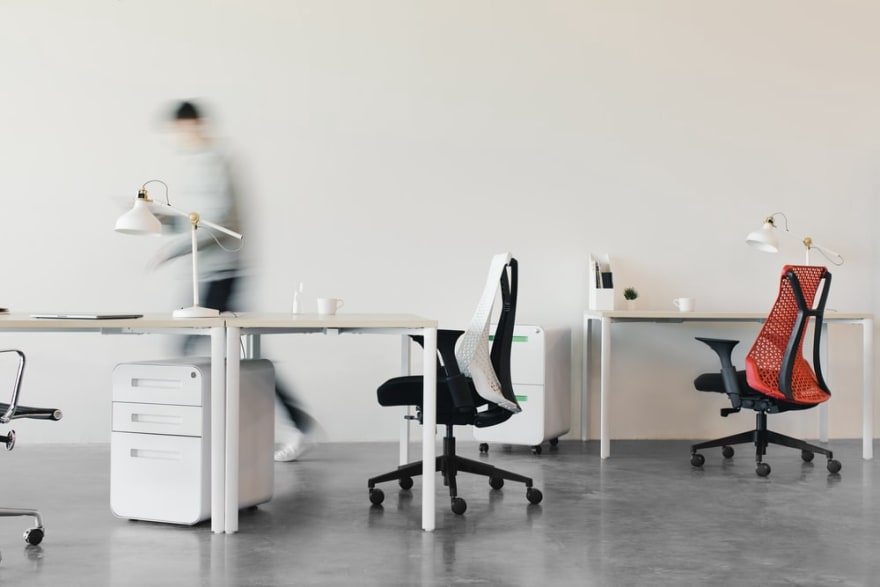 Photo of an office with a blurred person walking